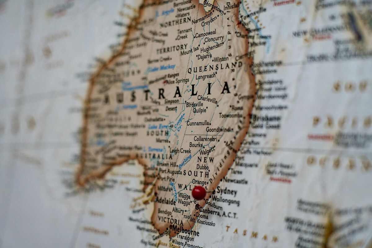 Close-up of a vintage printed map of Australia with a red push-pin in Sydney